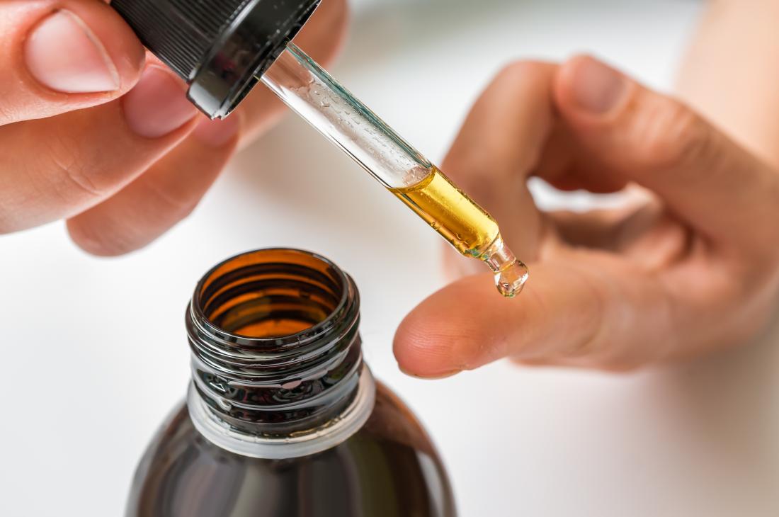 essential oil being tested on skin on finger using dropper
