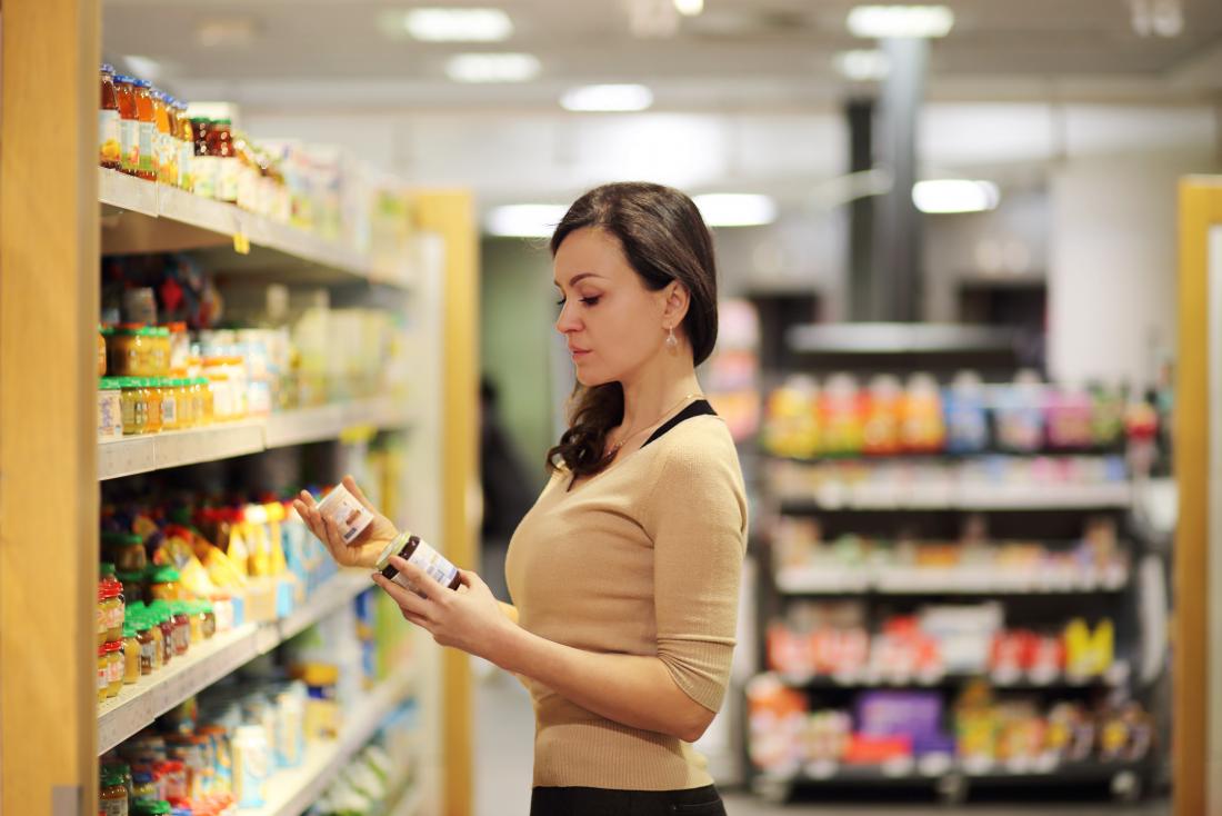 Woman reading the label of supplements