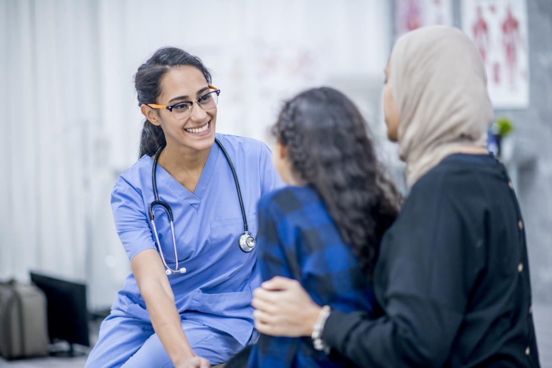 Doctor speaking with patient and child
