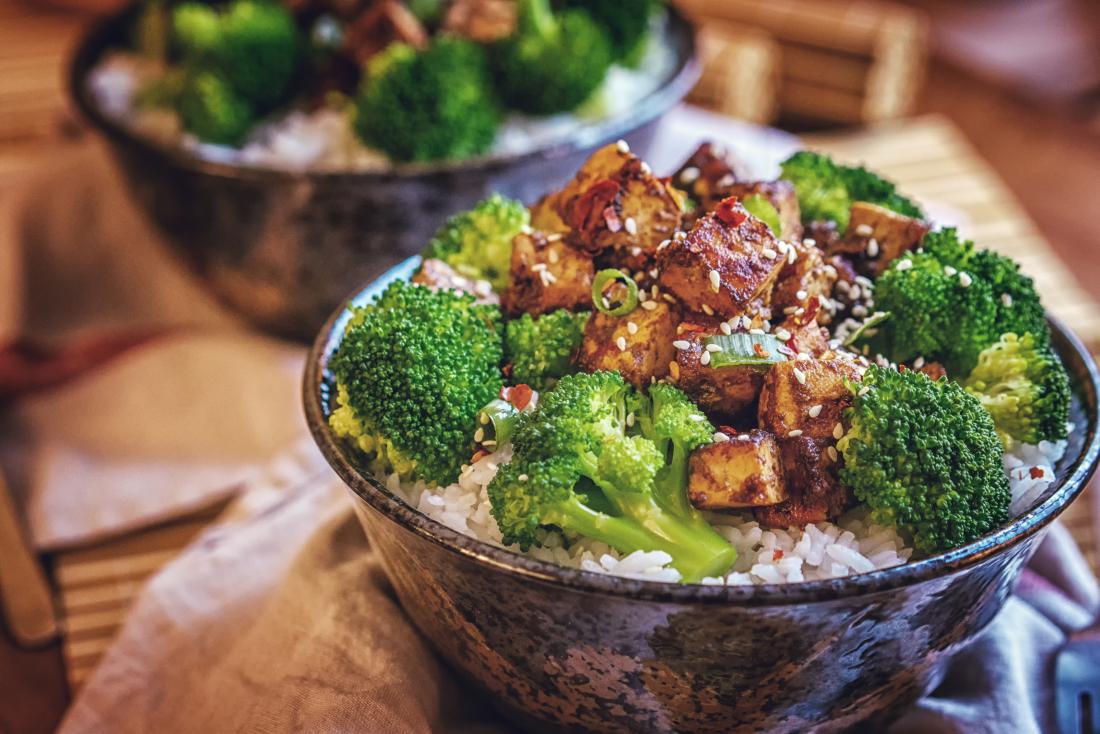 broccoli, tofu, rice and seeds in a bowl