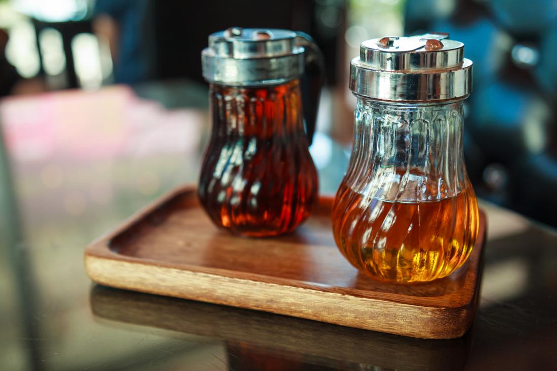 Bottles of syrup on wooden tray