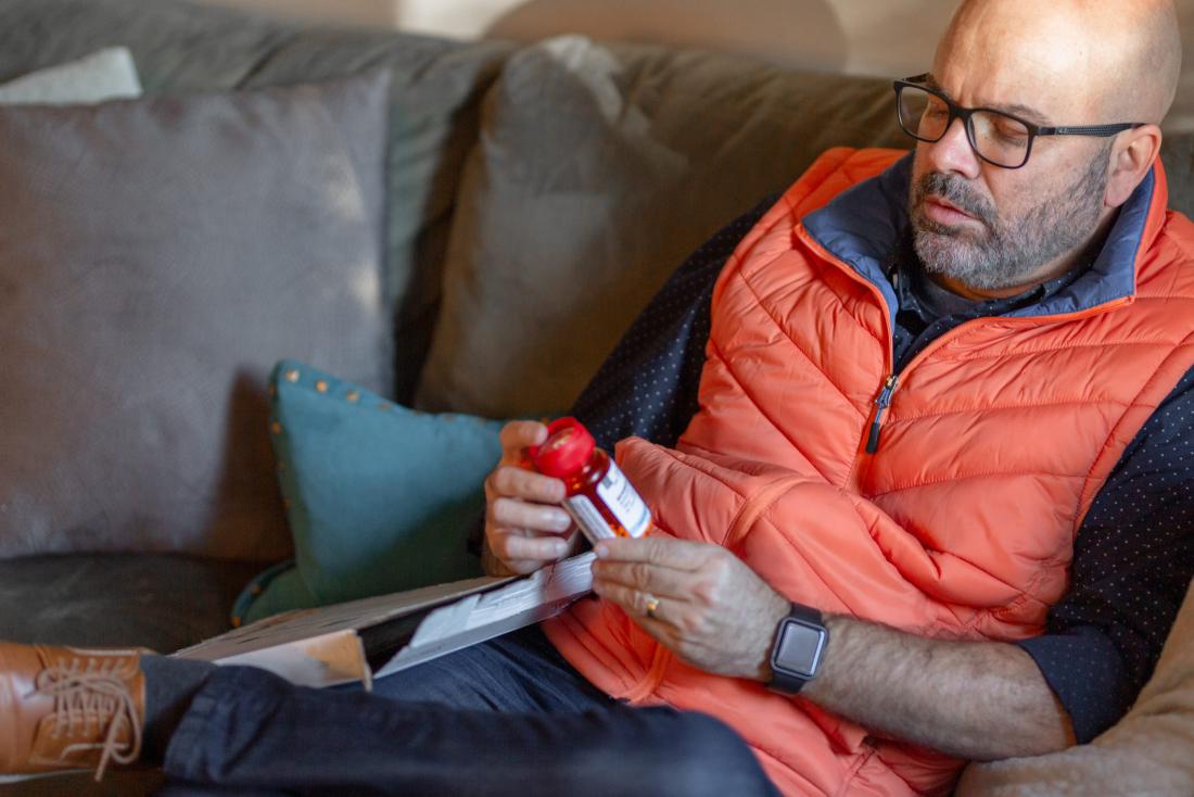Man reading pill bottle