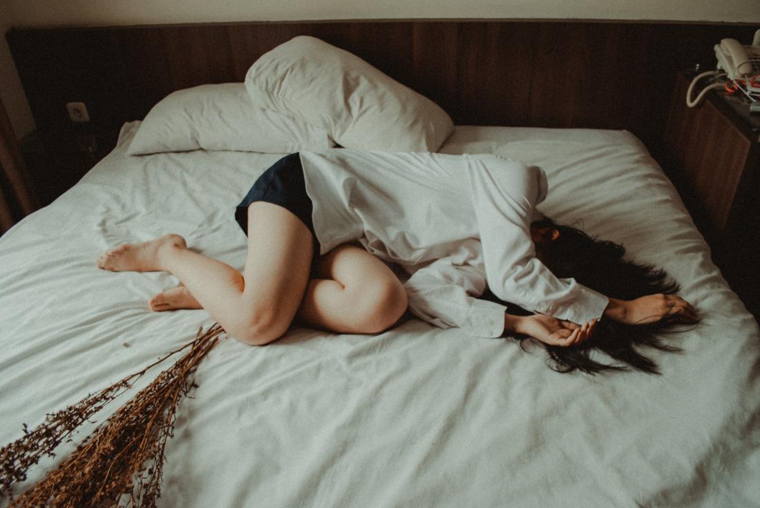 person lying across the bed