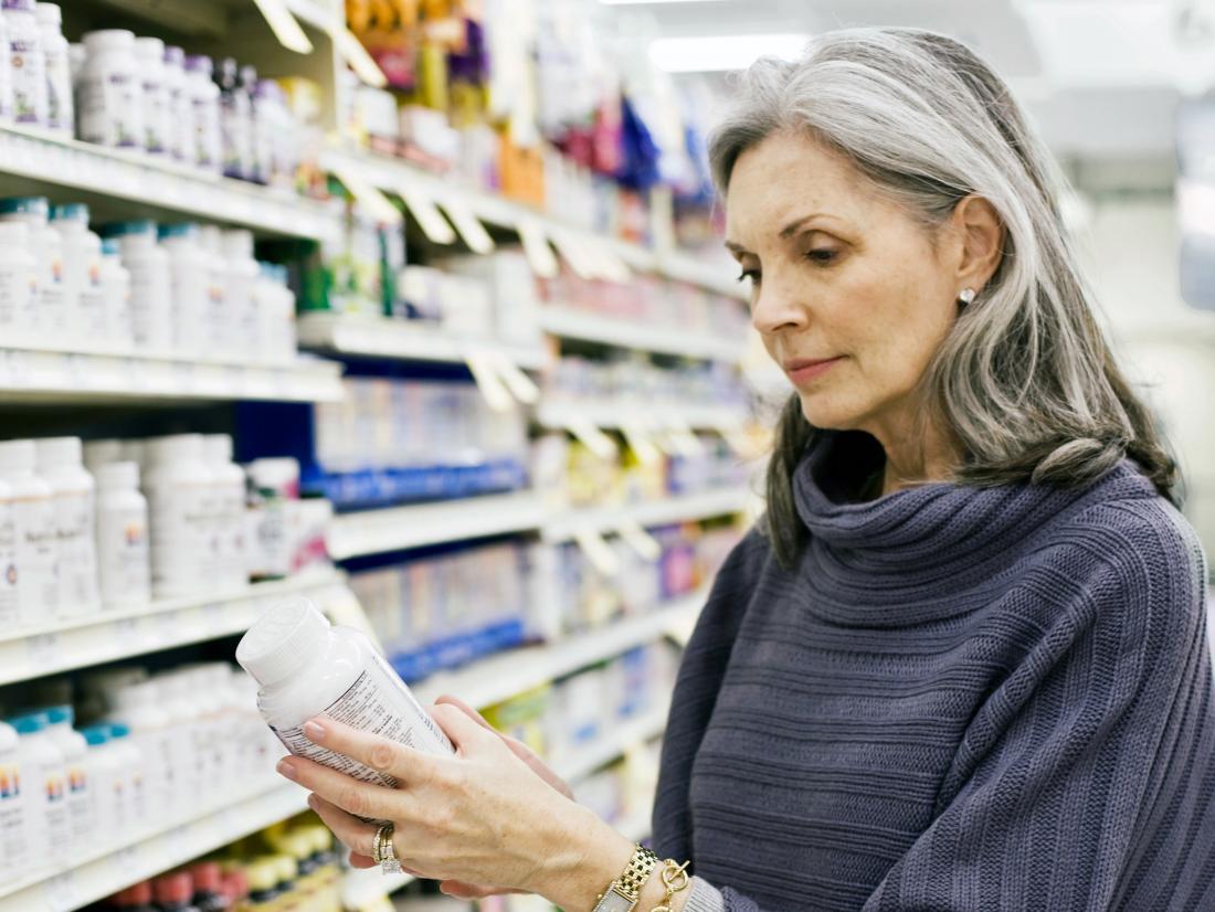 a woman in a pharmacy looking at supplements for neuropathy