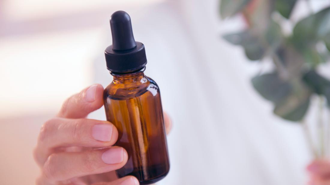 a person holding a tub of castor oil 