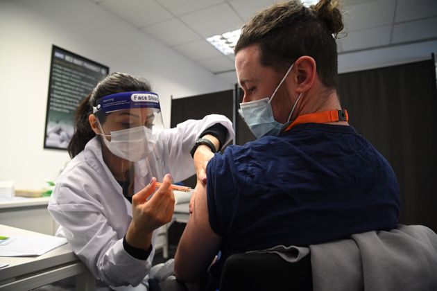 A care worker receives the Oxford-AstraZeneca Covid-19 vaccine in