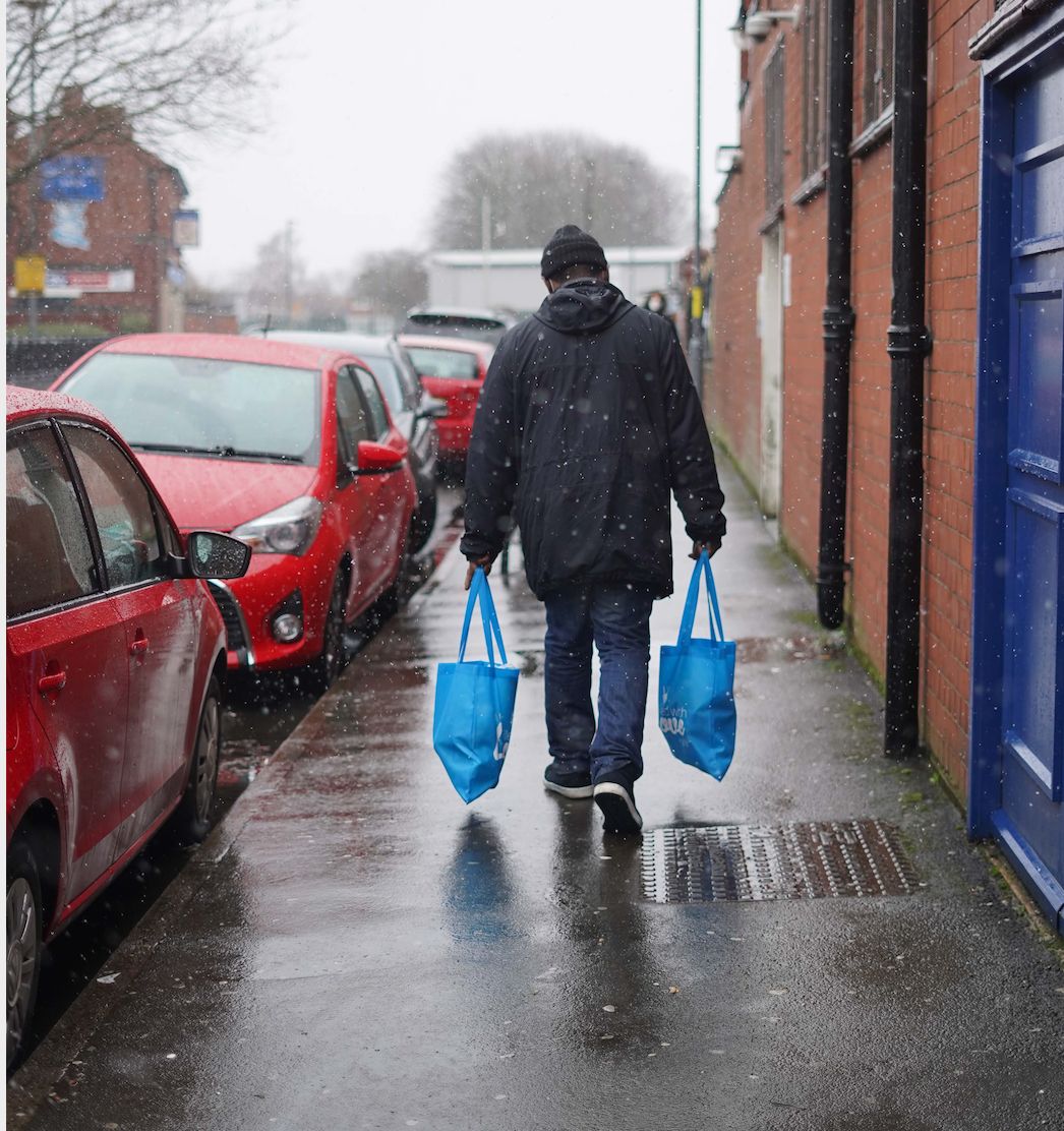 A man carrying food parcels to help those in