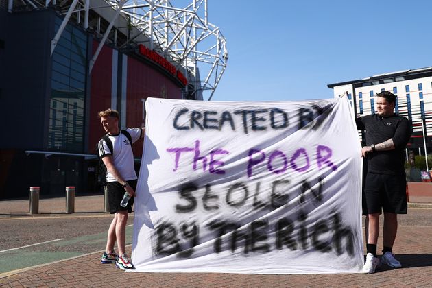 Football fans opposing the European Super League outside Manchester United's Old Trafford stadium on