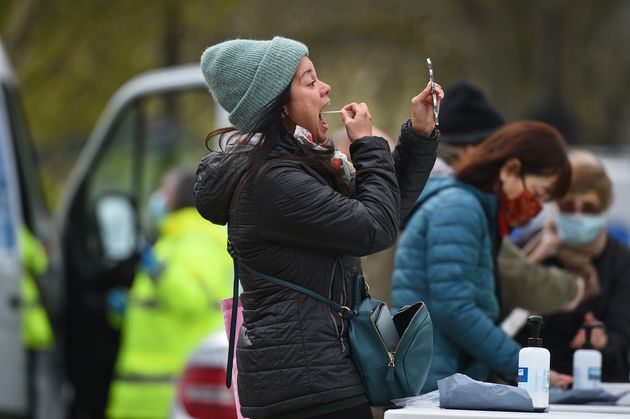 People take part in coronavirus surge testing on Clapham Common, south