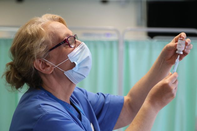 A nurse fills a syringe with the Moderna Covid-19 vaccine at a vaccination centre in Llanelli, South