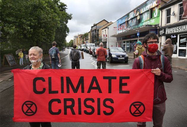 Protesters hold a banner saying climate crisis during the demonstration in