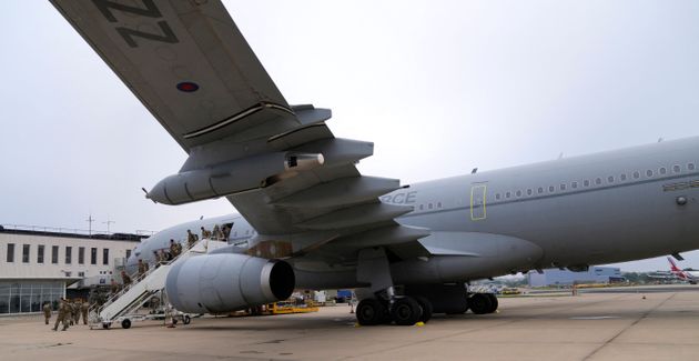 Members of the British armed forces 16 Air Assault Brigade walk to the air terminal after disembarking...
