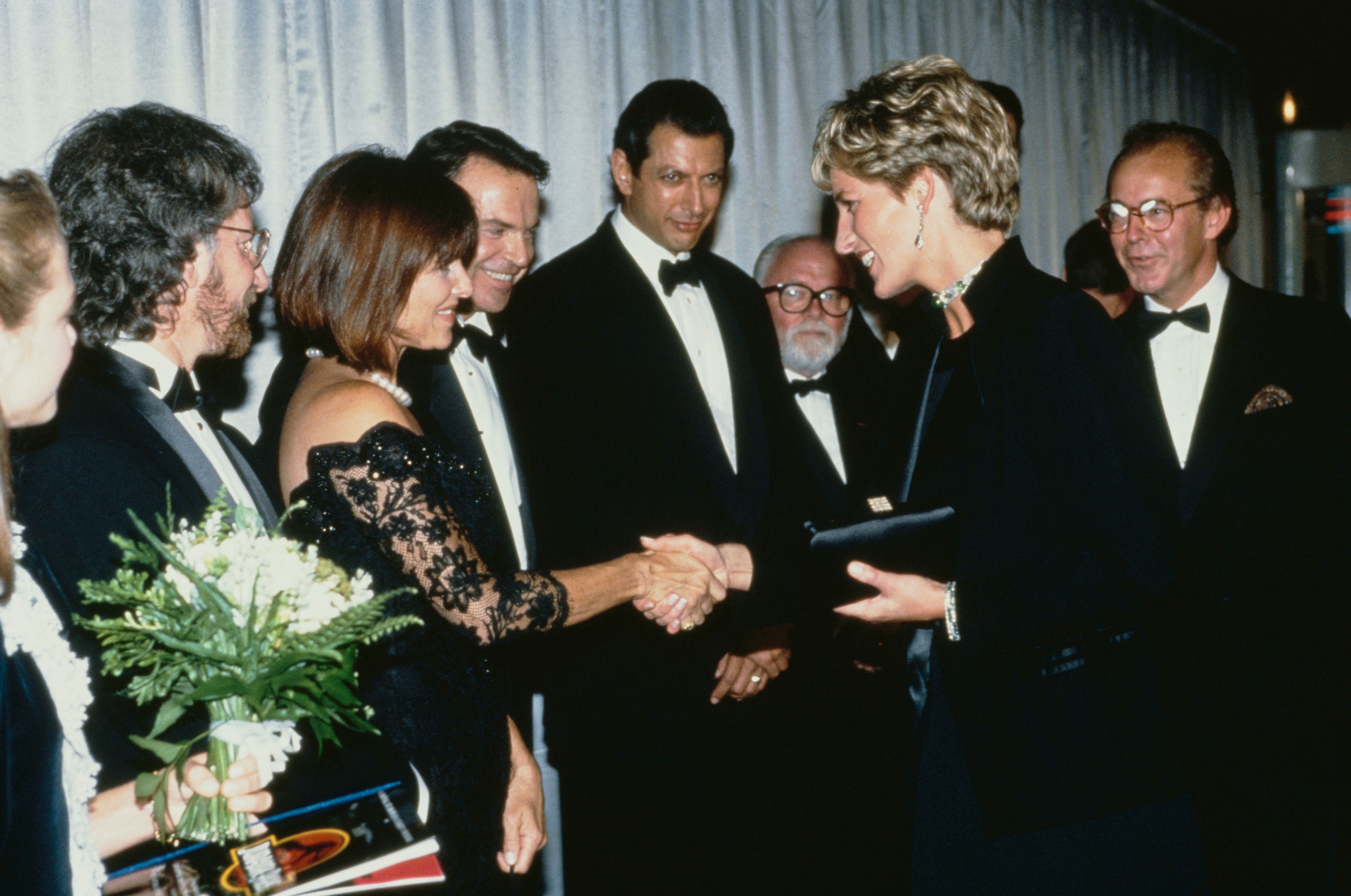 Diana, Princess of Wales (1961 - 1997) attends the premiere of the Steven Spielberg film 'Jurassic Park' in London, 15th July 1993. From left to right, she is meeting star Ariana Richards, director Spielberg and his wife Kate Capshaw, and stars Sam Neill, Jeff Goldblum and Richard Attenborough. (Photo by Princess Diana Archive/Getty Images)