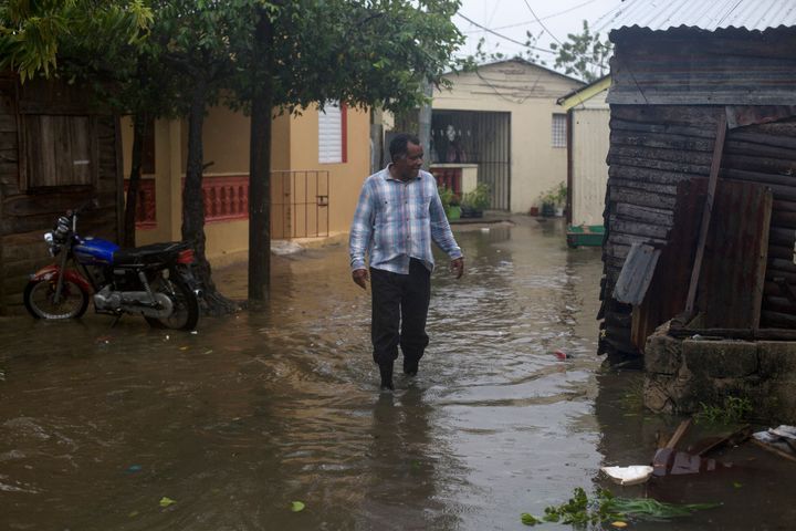A man wades through a flooded street in Nagua, Dominican Republic, on September 19