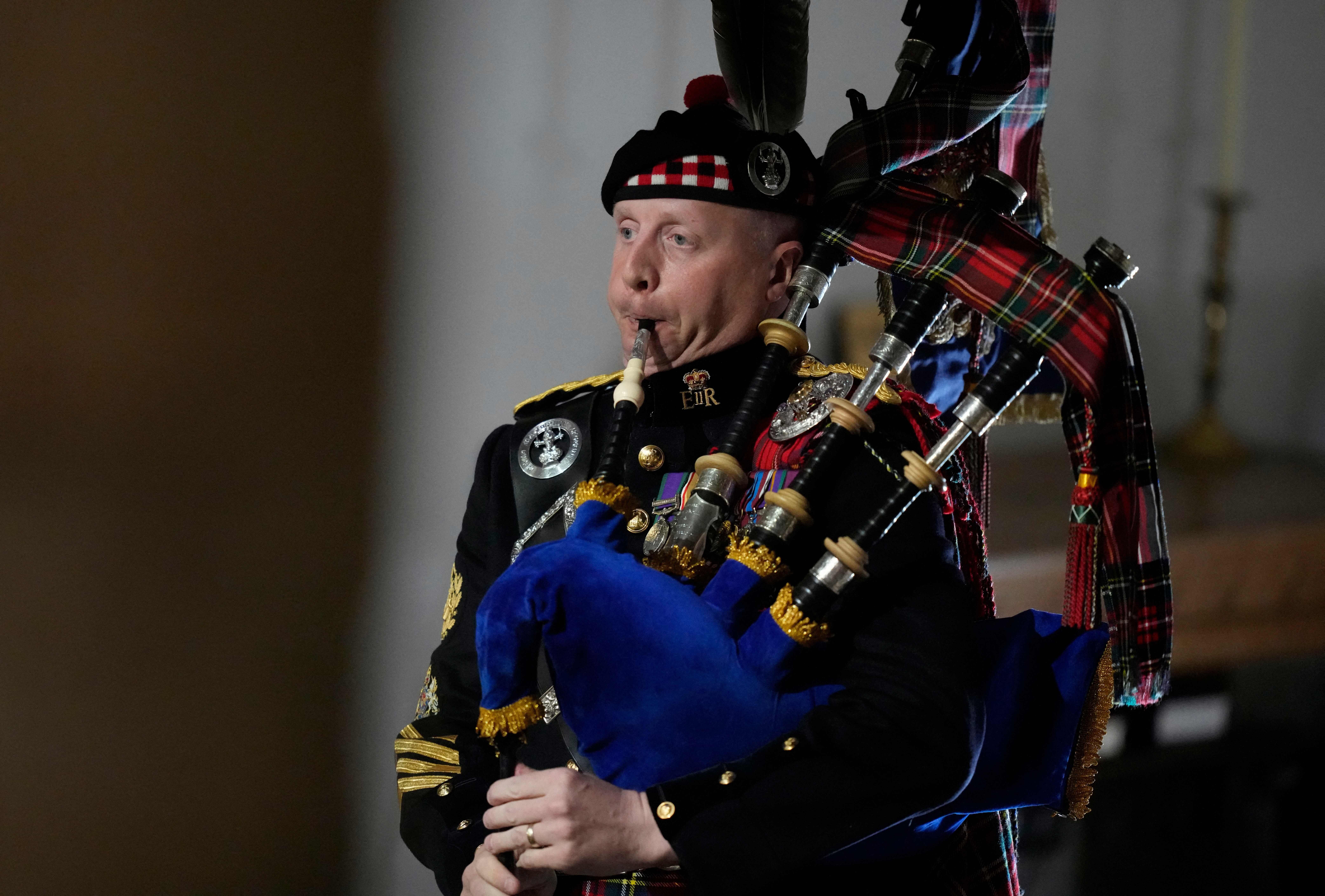 Pipe Major Paul Burns plays at the funeral of Queen Elizabeth II at Westminster Abbey in central London on Sept. 19, 2022.