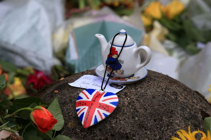 A Paddington Bear teapot is seen with floral tributes left outside the Sandringham Estate in Norfolk