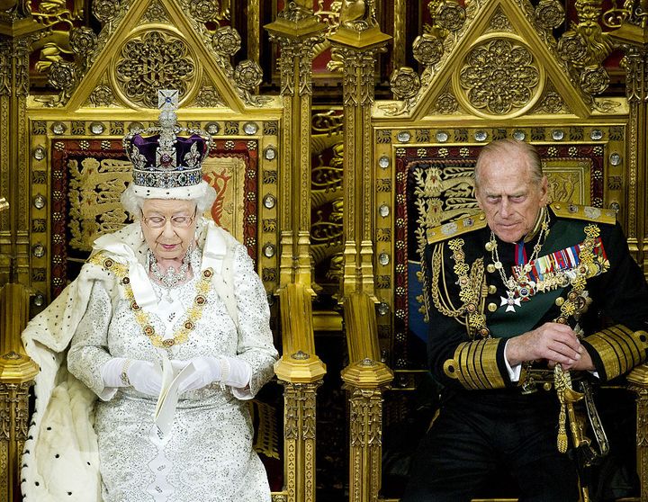 The Queen and Prince Philip seated on thrones in the House of Lords at the state opening of parliament in 2013