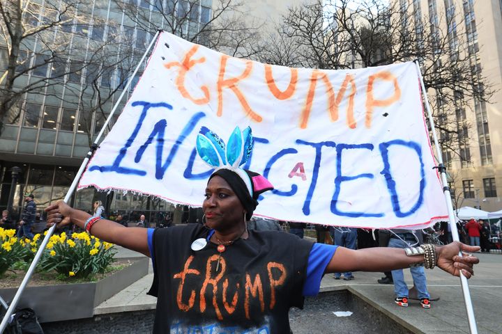 Demonstrators protest against former president Donald Trump at Collect Pond Park near the courthouse ahead of his arraignment hearing in New York city.