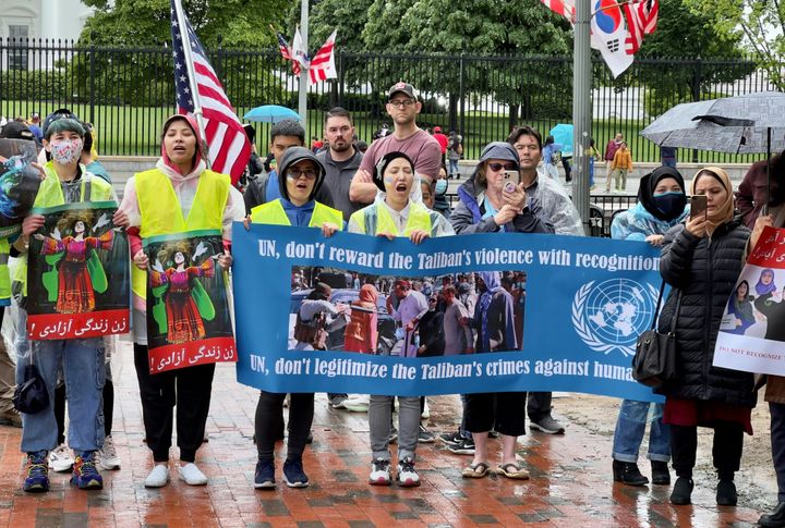 Activists against the U.N. formally recognizing the Taliban hold banners during a demonstration in front of the White House in Washington, D.C., on April 30.