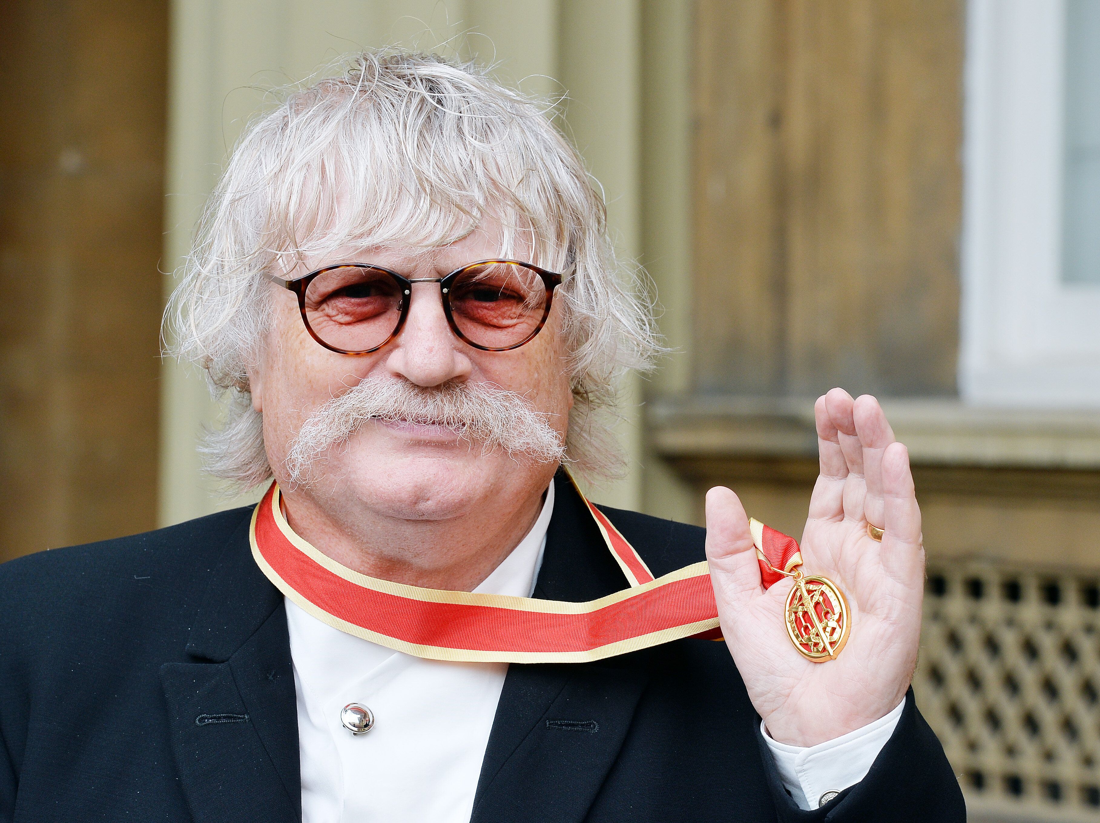 Sir Karl Jenkins holds his Insignia of Knighthood award after it was presented at Buckingham Palace on Oct. 6, 2015.
