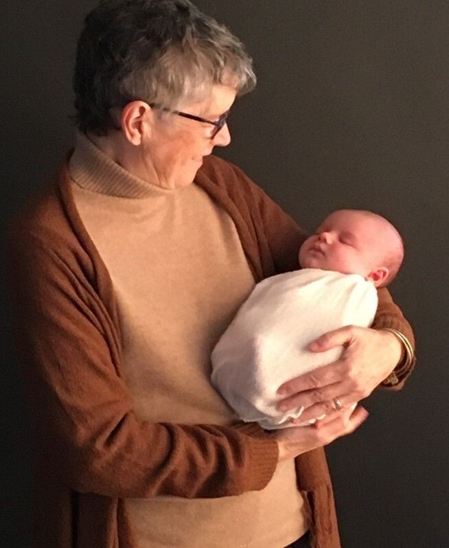 Sue is pictured meeting her sixth grandchild, just six weeks before she died.