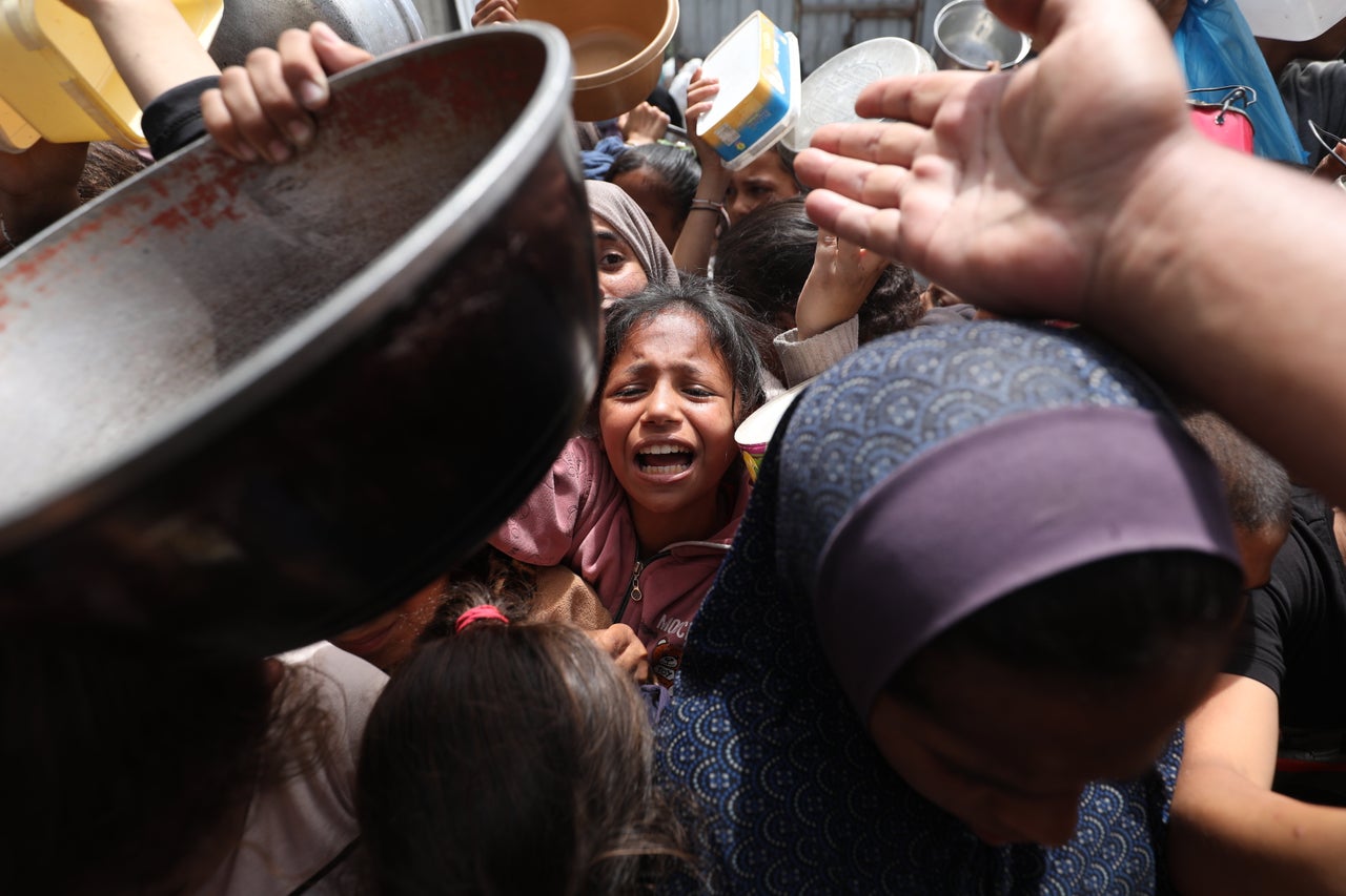 Palestinians crowd together in hopes of receiving a hot meal, in Nuseirat refugee camp, in Gaza on May 13. Israel's total blockade on food and humanitarian assistance has led to the mass starvation of Palestinian children.