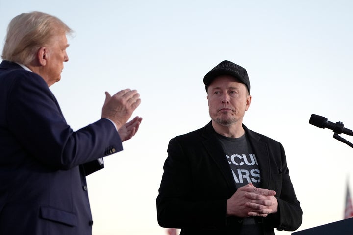  Donald Trump, left, claps as Tesla and SpaceX CEO Elon Musk in October