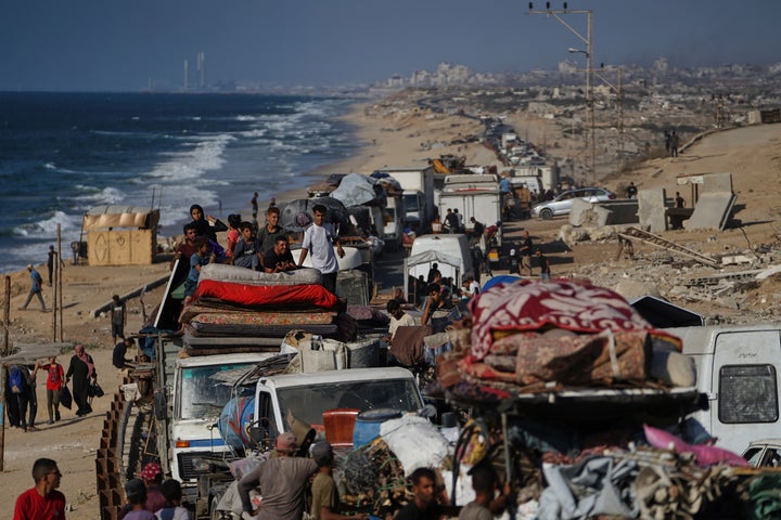 Displaced Palestinians fleeing northern Gaza carry their belongings along the coastal road toward southern Gaza, Tuesday, Sept. 9, 2025, after the Israeli army issued evacuation orders from Gaza City.
