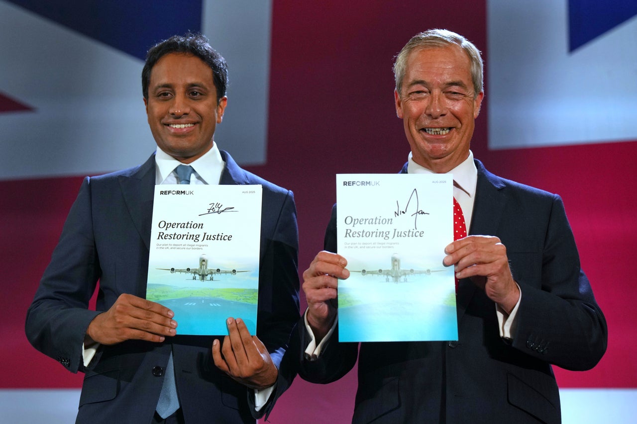 British Reform party leader Nigel Farage and Zia Yusuf, left, show the program Operation Restoring Justice during a press conference in a hangar at Oxford Airport in Kidlington, England, Tuesday, Aug. 26, 2025.