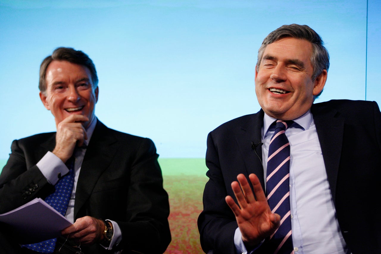 Ex-Prime Minister and Labour Party leader, Gordon Brown, right, and then-Business Secretary Peter Mandelson react as they speak to the media about economy in a press conference in London, Monday, April 19, 2010.