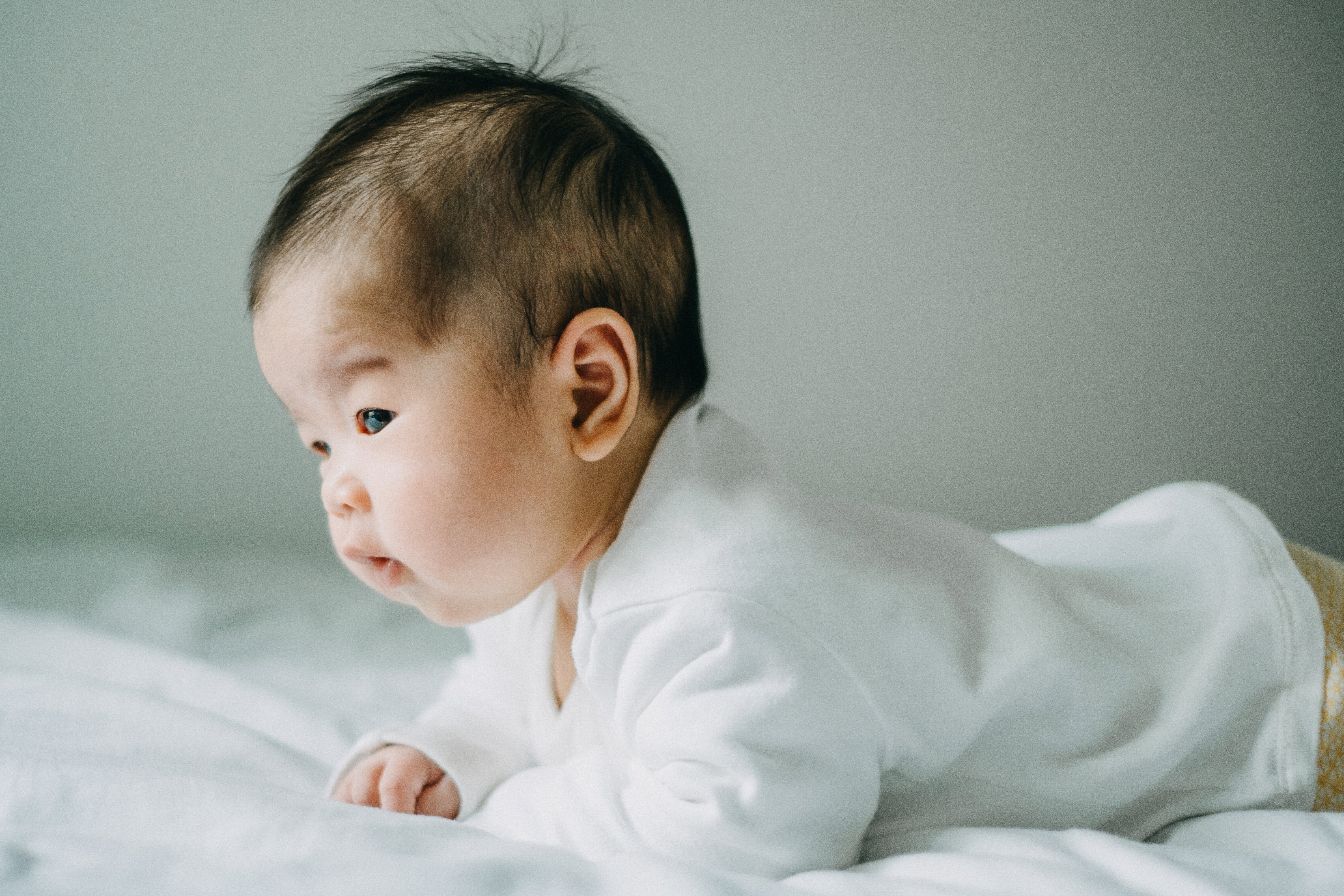 This baby perfectly demonstrates tummy time, an activity that helps build strength and mobility.