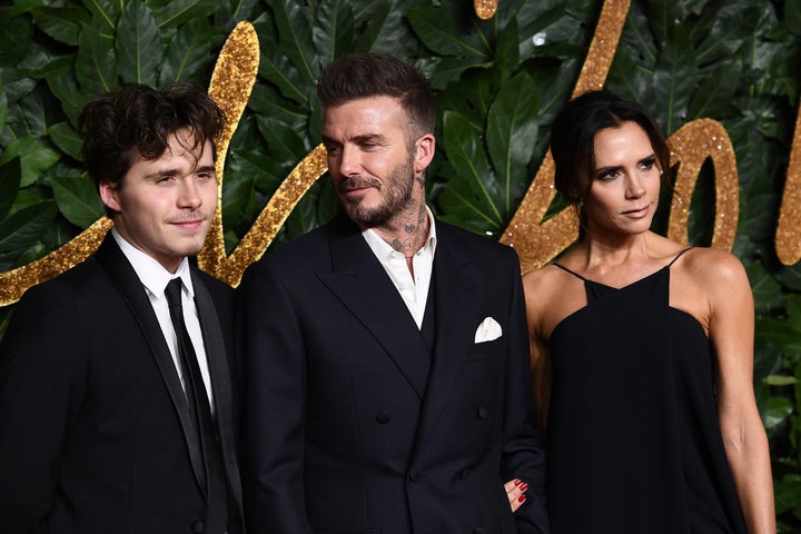 Brooklyn Peltz Beckham with his parents, Sir David and Victoria Beckham, in 2018.