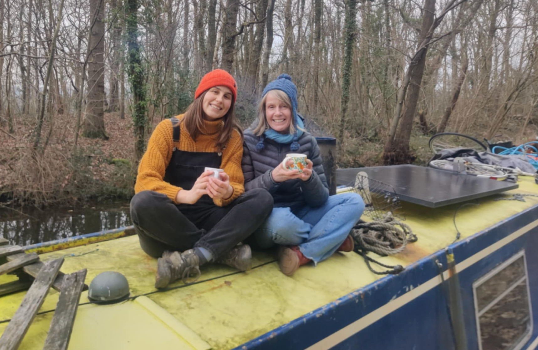 The author (right) having a cup of tea with a houseboat dweller while cruising up the canal.