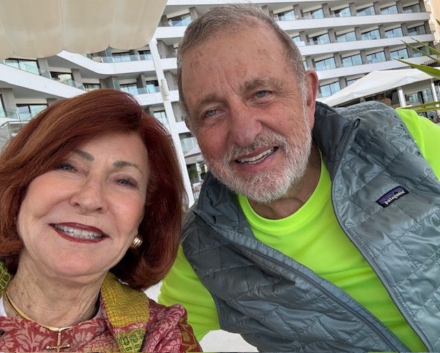 The author and Bob enjoying a drink by their hotel's pool, overlooking the beautiful yacht basin in Mallorca.