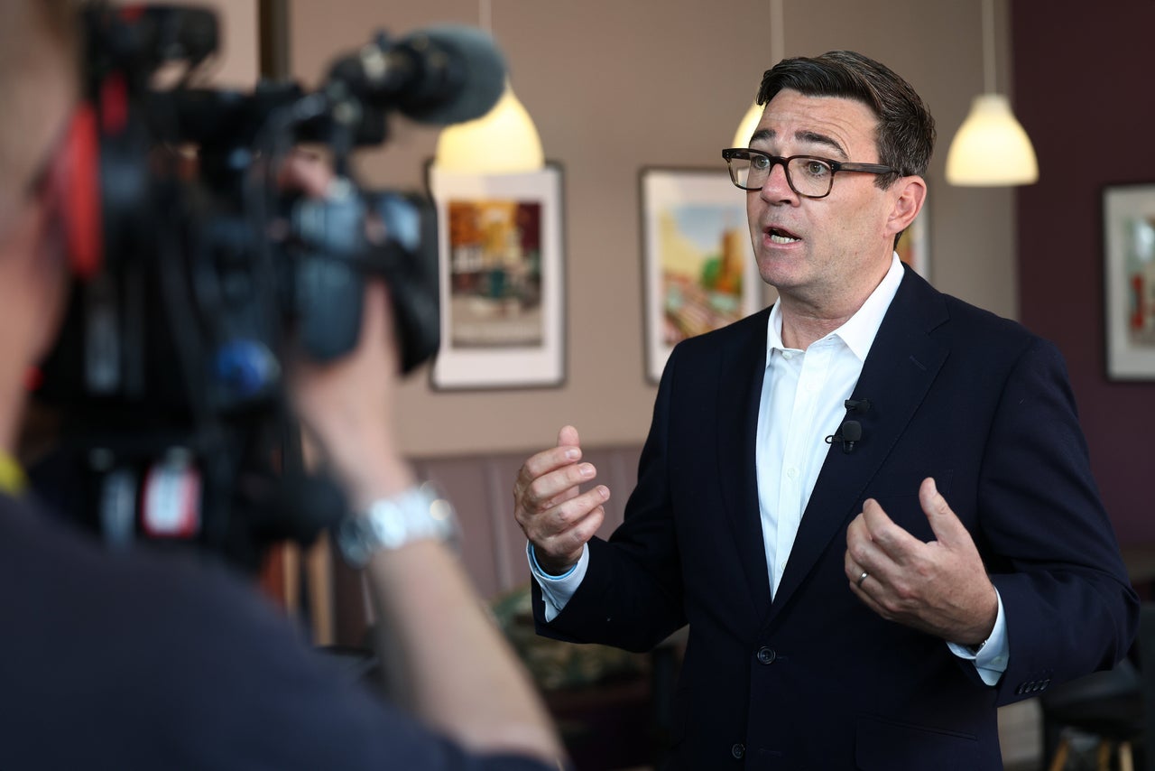 Britain's Prime Minister Andy Burnham speaks during a TV interview at The Hub Cafe following a visit to Ilkeston, Derbyshire, England, Tuesday, Aug. 11, 2026.