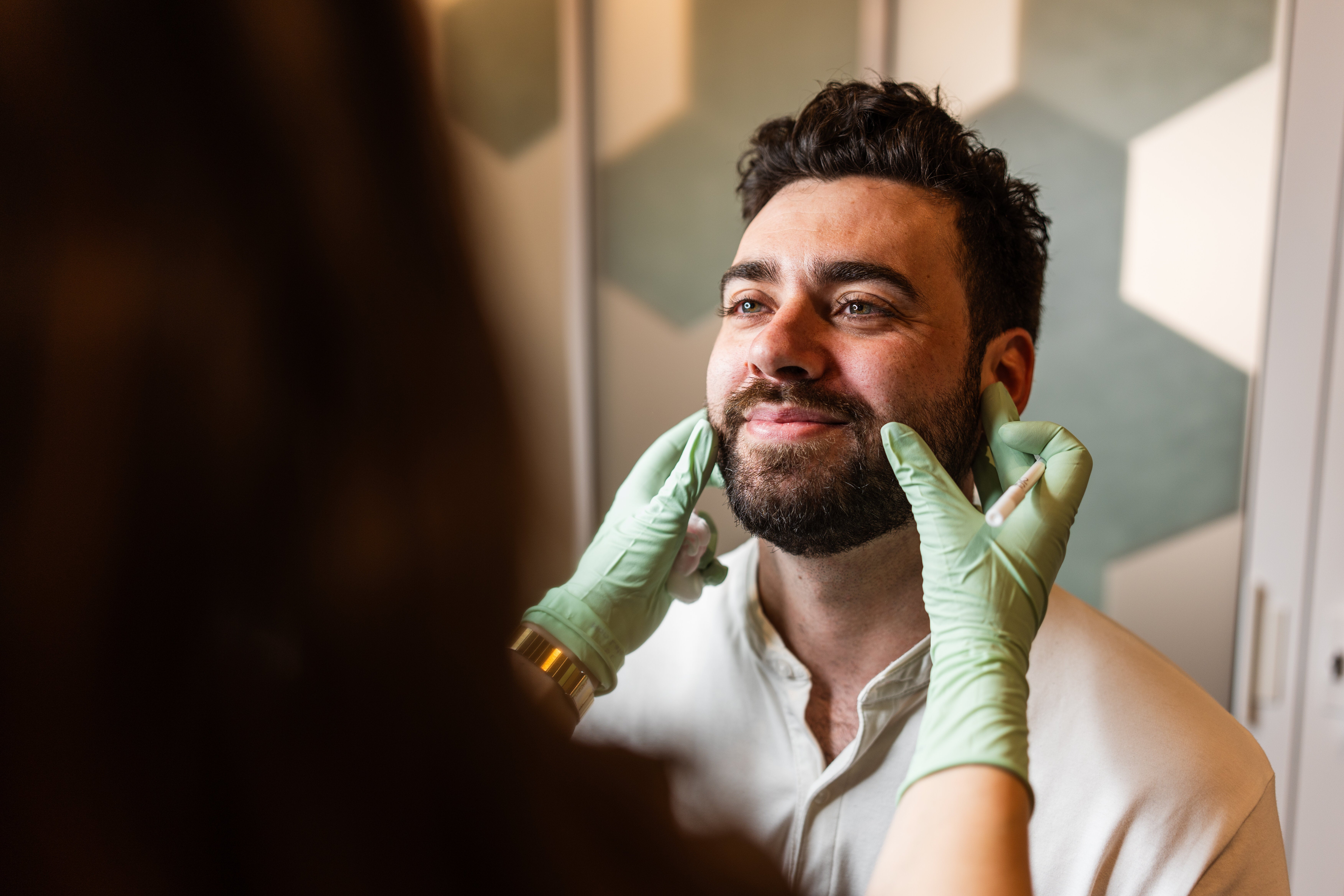 Men often notice structural changes that soften the lower face and make the once-distinct separation between the face and neck less defined.