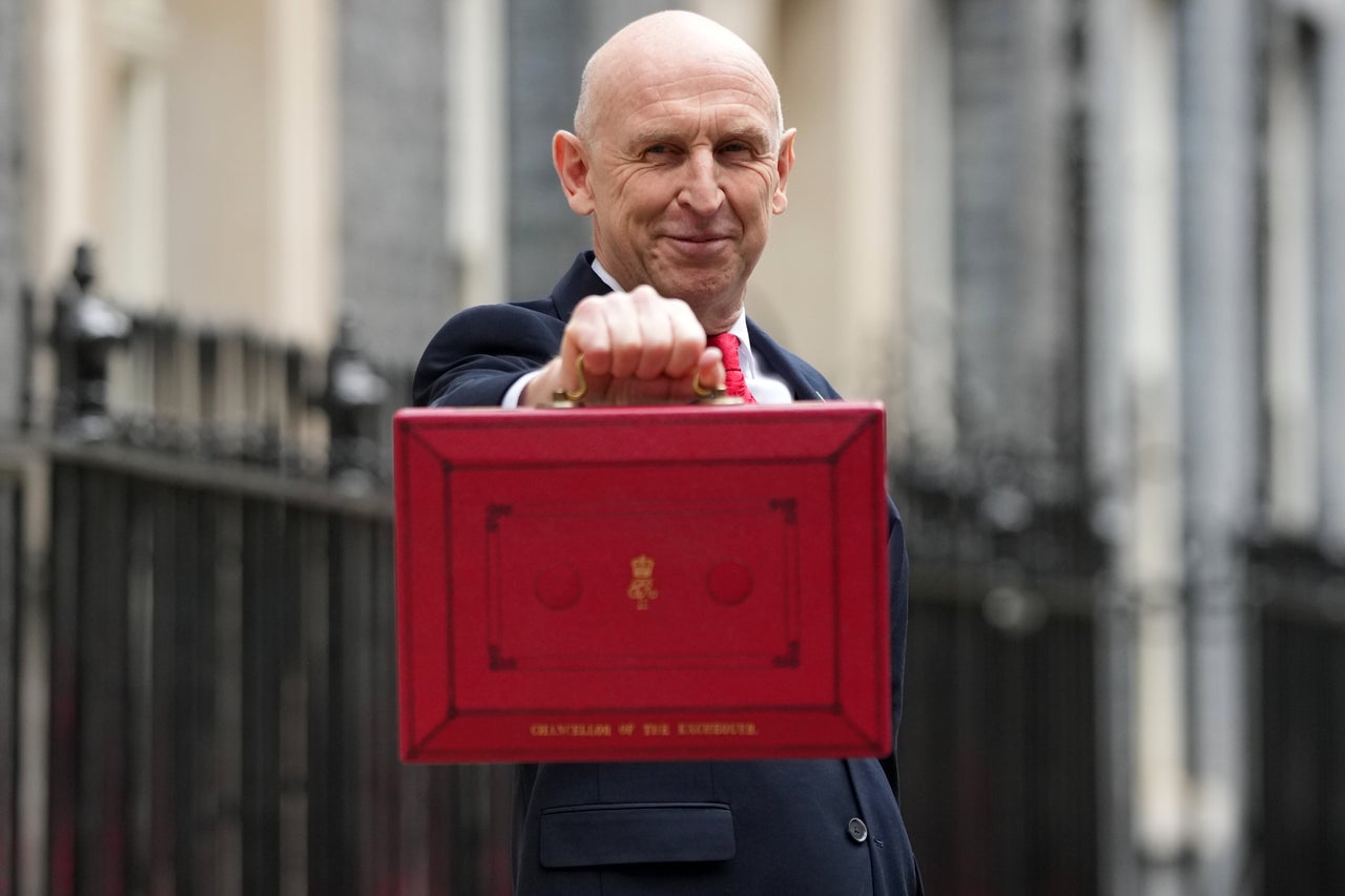 Britain's Chancellor of the Exchequer John Healey poses on the doorstep of 11 Downing Street with the ministerial red box before heading to the House of Commons to deliver the budget statement in London, Wednesday, Oct. 28, 2026.(AP Photo/Alastair Grant)