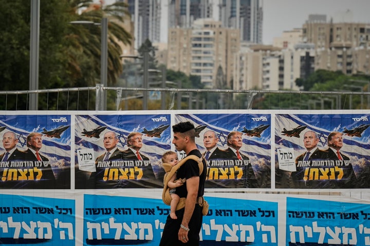 A man walks past a Likud Party campaign banner featuring Israeli Prime Minister Benjamin Netanyahu and U.S. President Donald Trump, with a Hebrew message reading, "We have one opportunity to win," in Tel Aviv Tuesday, Oct. 27, 2026, during Israel's general election.